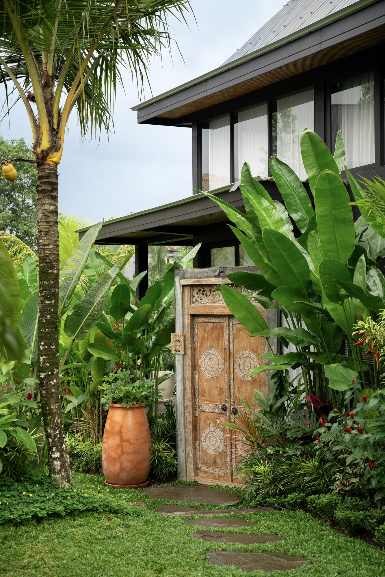 Lorel Green Domain carved door garden Ubud