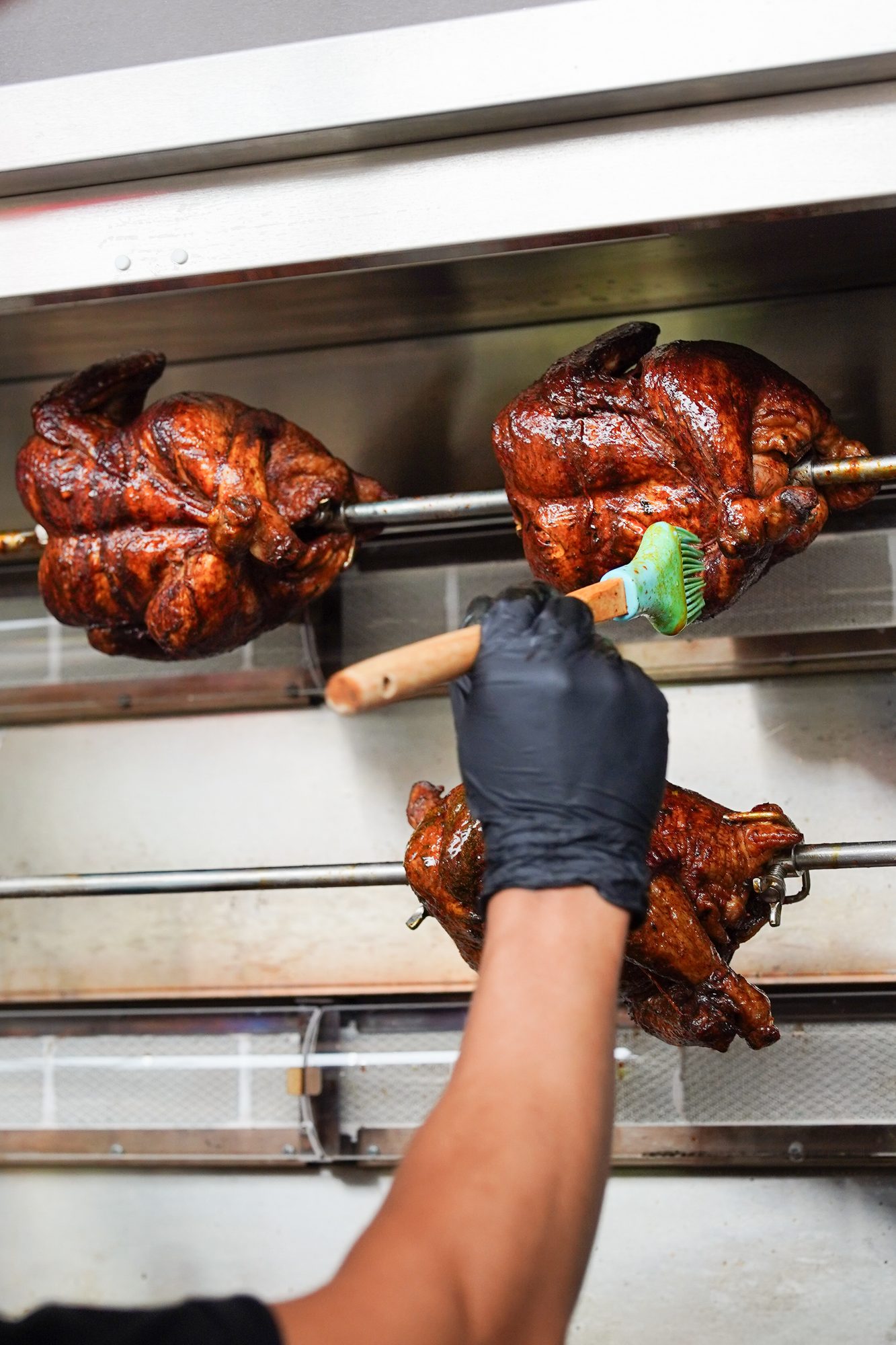 Rotisserie Bali chicken basting kitchen action